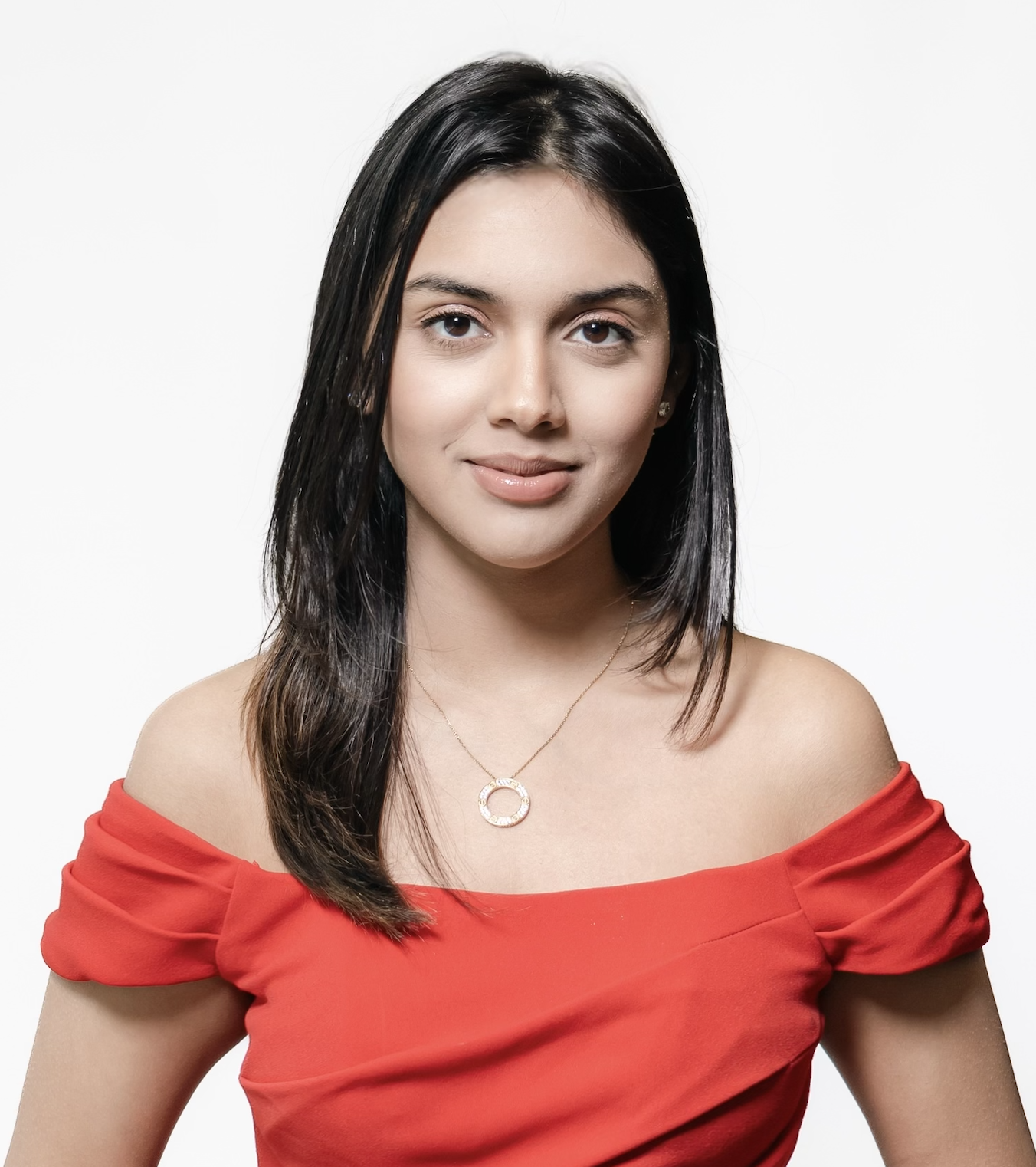 Alisha Arora smiling in a red dress